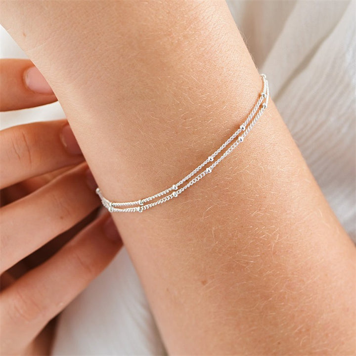 Armbånd i lag med små kugler i rustfrit stål